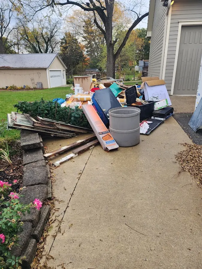 Dumpster being loaded with debris for Estate Cleanout Dumpster Rental in Grain Valley